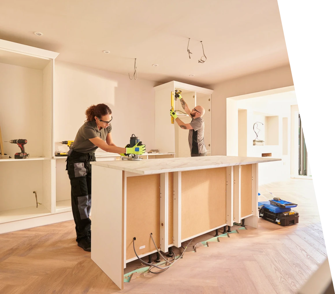 Kitchen renovation with two people working.