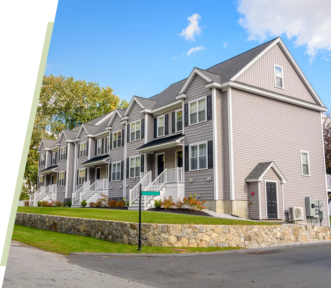 Row of modern townhouses on sunny day.