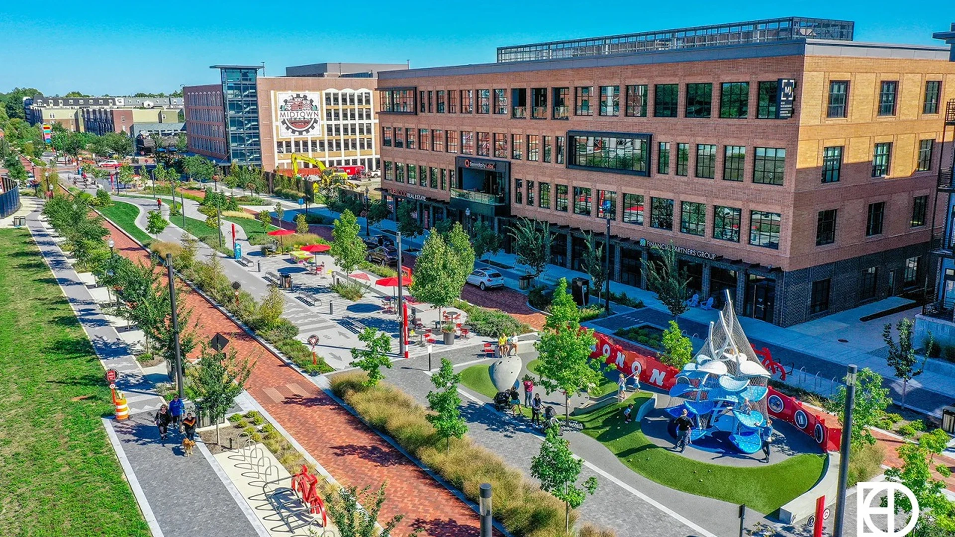 Urban park with pathways and modern buildings.